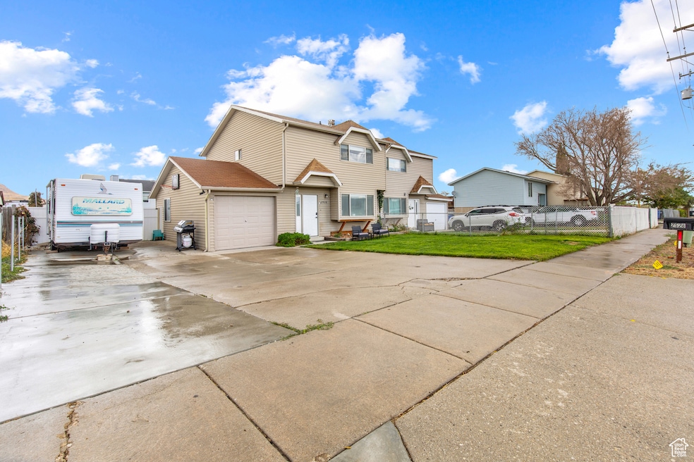 Home featuring concrete driveway and RV parking