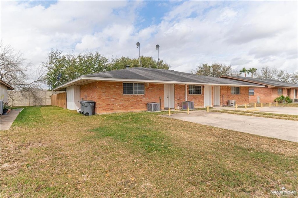 Ranch-style home with a front lawn, central air condition unit, fence, and brick siding