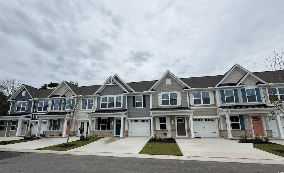 Craftsman-style home with a standing seam roof, stone siding, a metal roof, and a porch