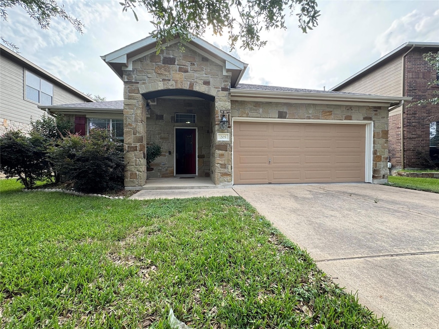 View of front of house featuring stone siding, an