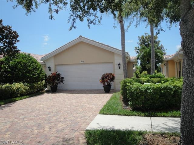 A paver brick driveway welcomes you to this wonder
