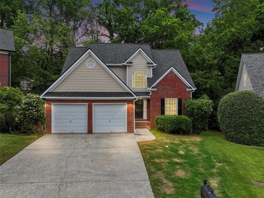 View of front of home featuring a garage and a law