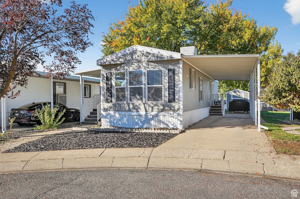 Manufactured / mobile home with a carport and driveway