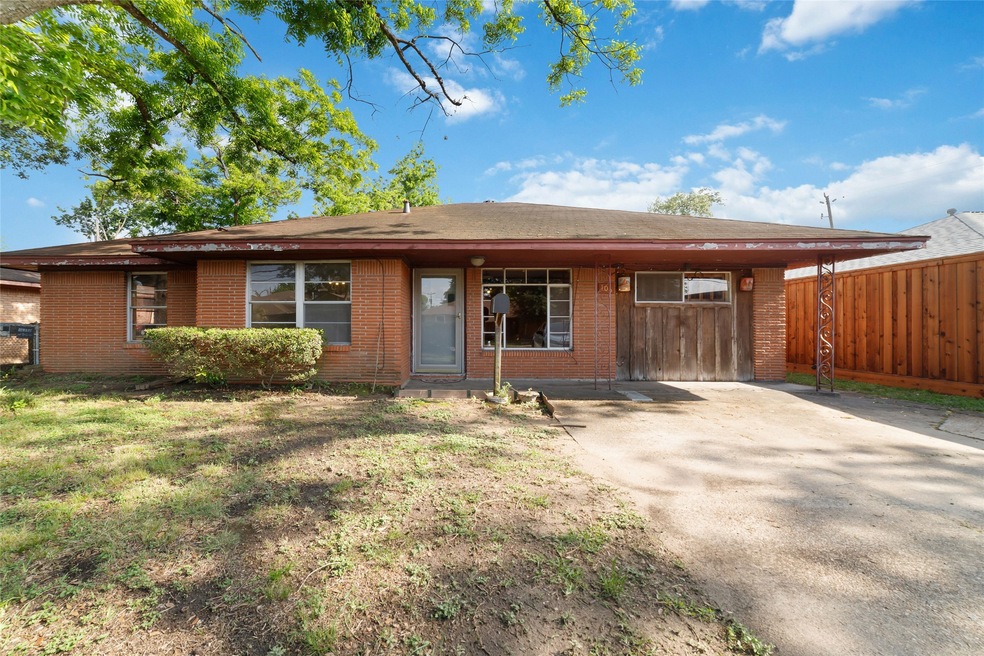 This single-story brick home features a charming f