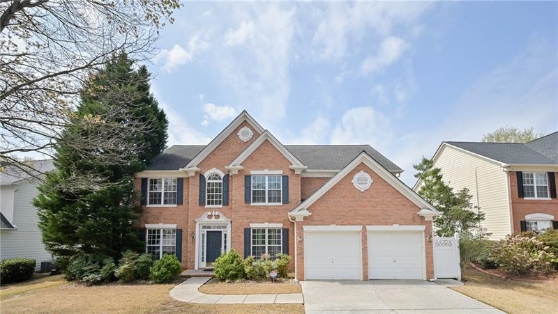 Beautiful brick-front home on a flat lot tucked ba