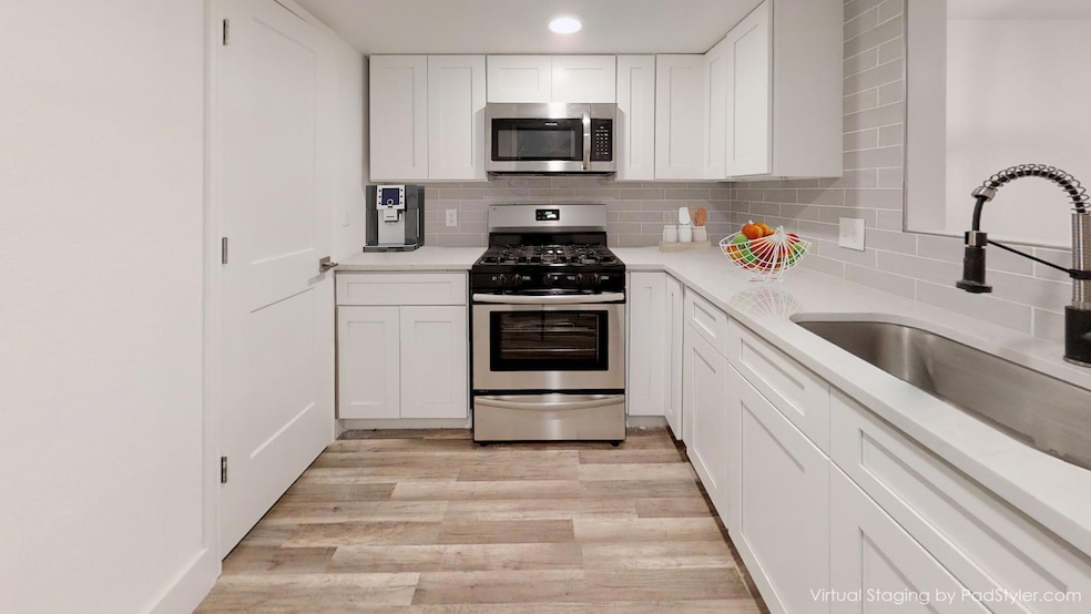 Kitchen with stainless steel appliances, a sink, 