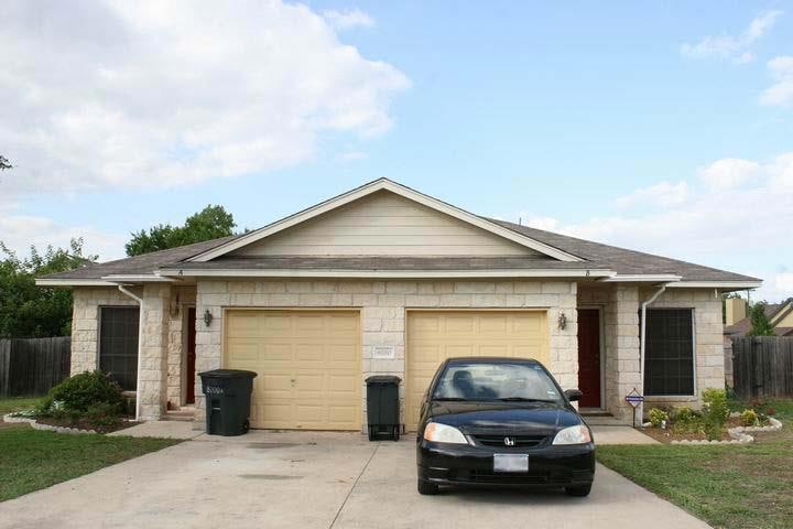 Ranch-style home featuring concrete driveway, a g