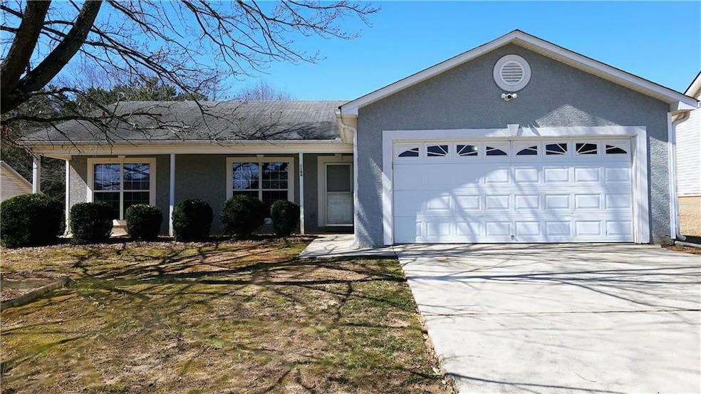 Ranch-style house with an attached garage, drivewa
