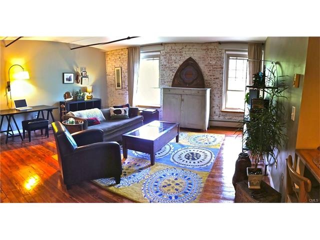 Hardwood floors throughout living space. Exposed b