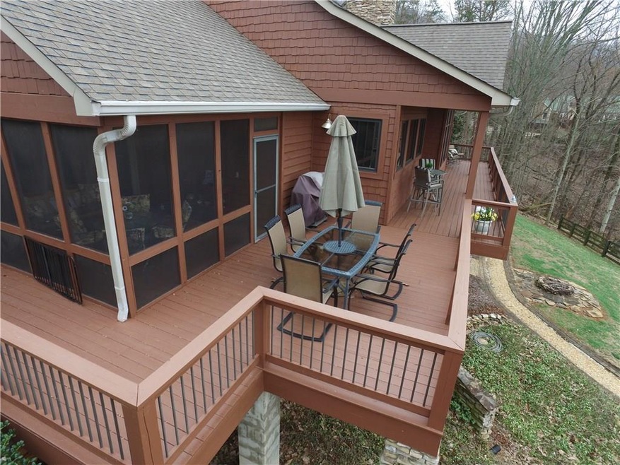 Close up view of screen porch and large deck.  See what great shape this home is in?????