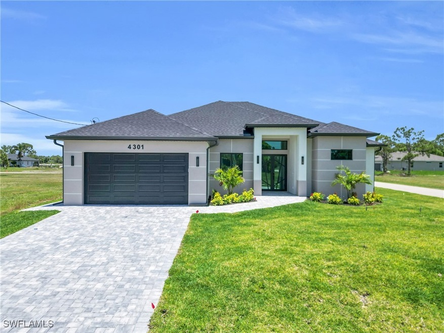 View of front facade with stucco siding, a front l