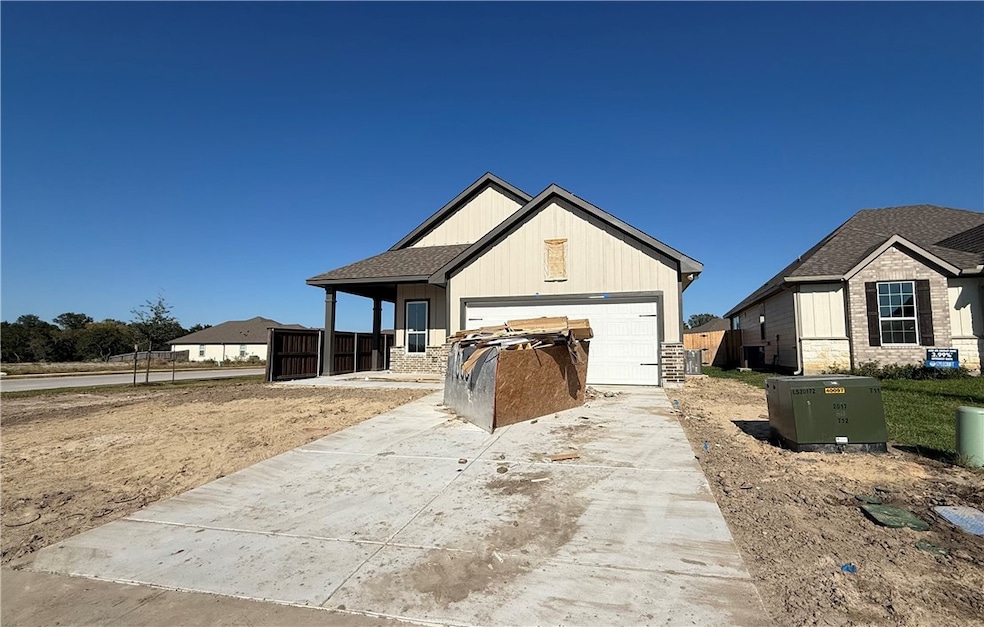 Modern farmhouse with driveway, a porch, and stone siding