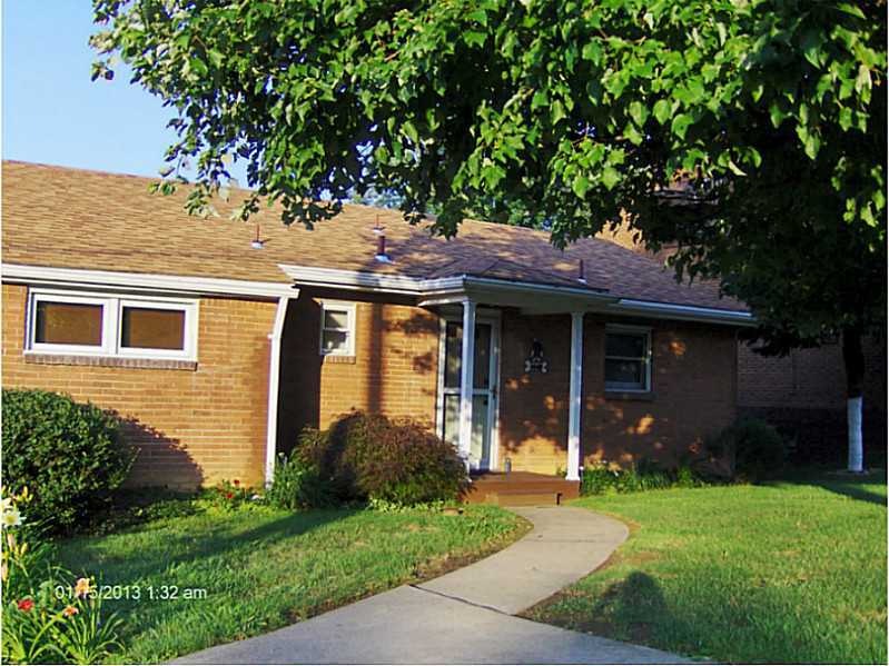Exterior Front. Beautiful manicured lawn.  All bri