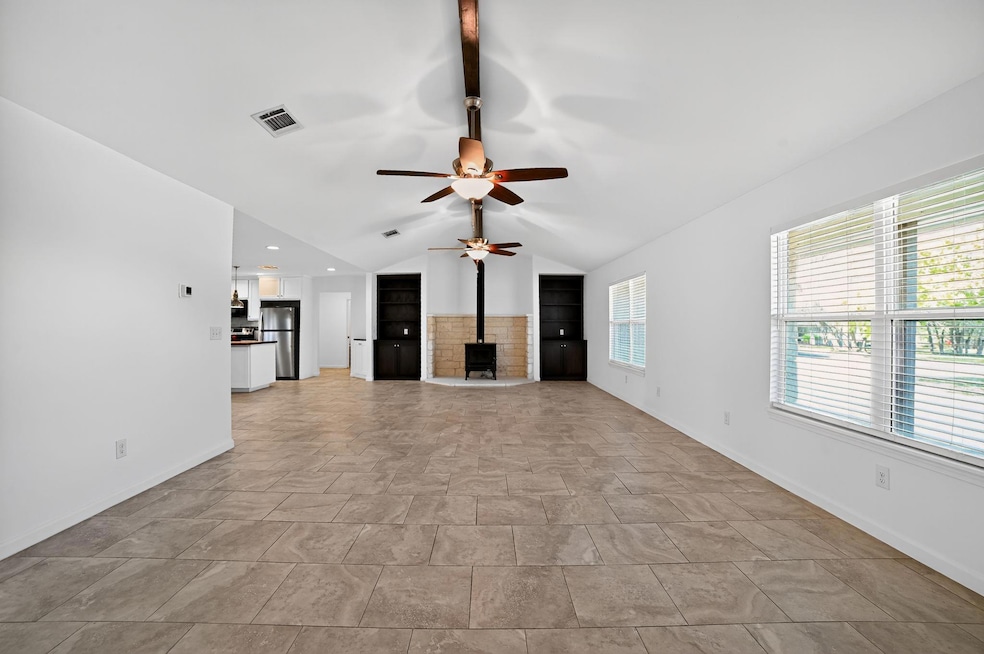 Unfurnished living room with vaulted ceiling, a c