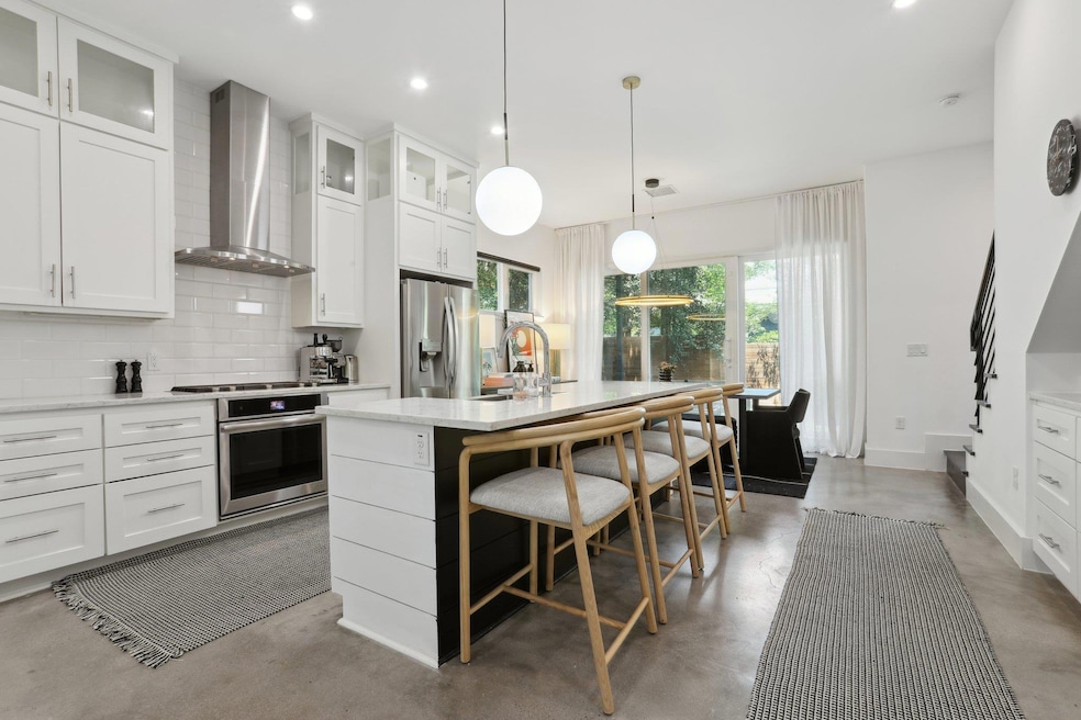 Kitchen with wall chimney range hood, stainless s