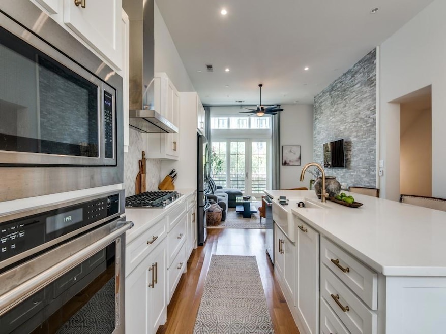 Kitchen with white cabinets, wood finished floors,