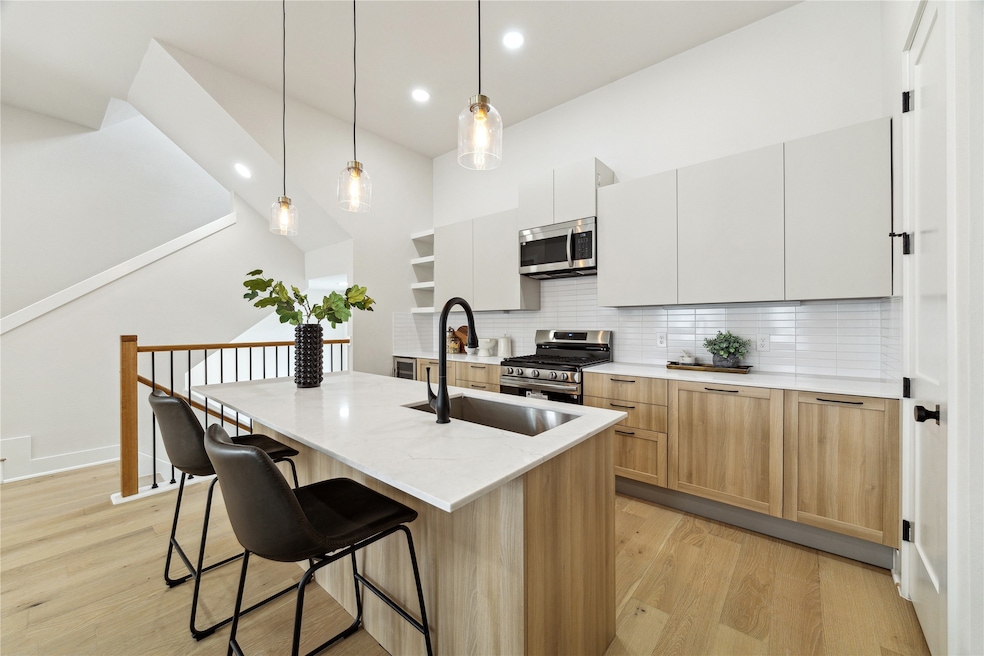 Sleek, modern kitchen featuring stainless steel ap