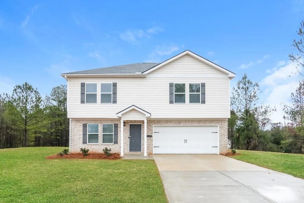 View of front facade with a front lawn and a garage