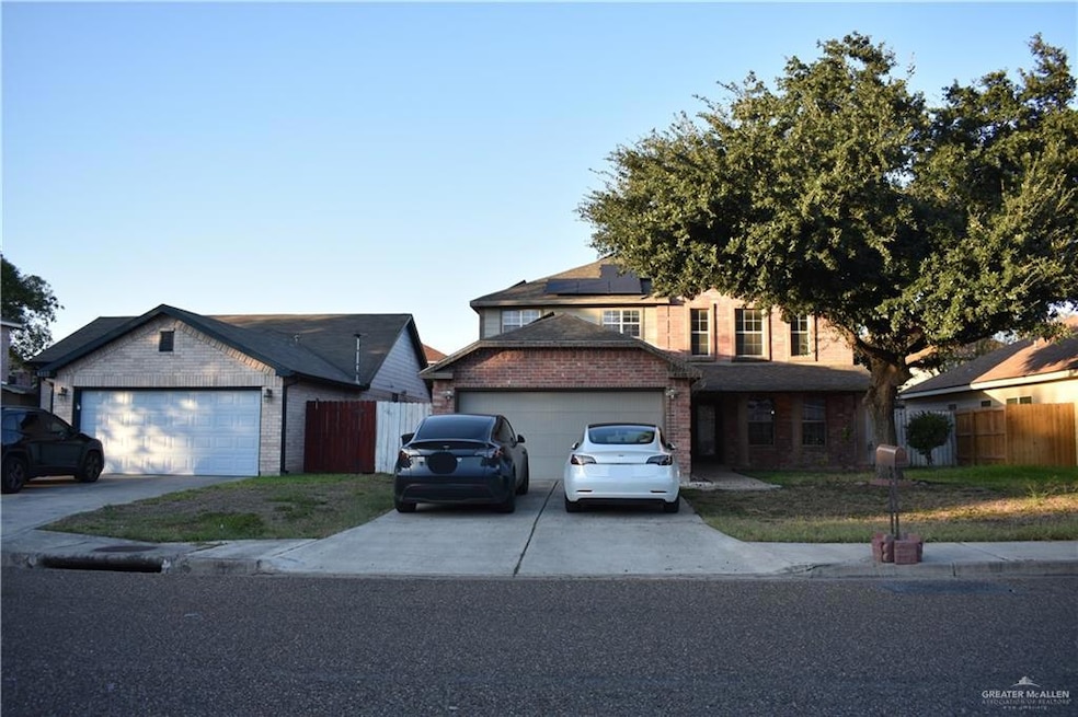 Traditional-style home with brick siding, driveway, solar panels, and a garage