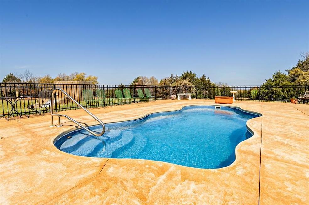 View of swimming pool featuring a fenced in pool, 