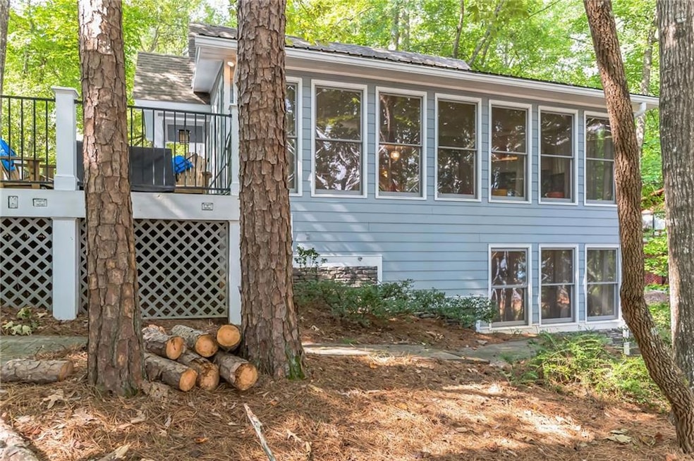 View of side of property with a wooden deck