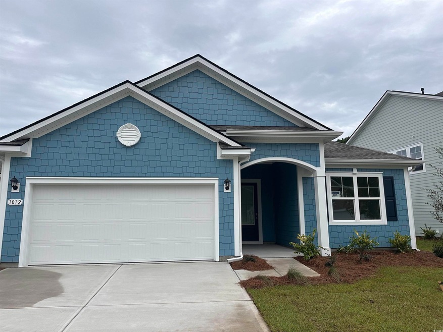 View of front facade featuring a garage