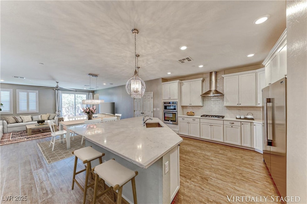 Kitchen with wall chimney range hood, gas cooktop,