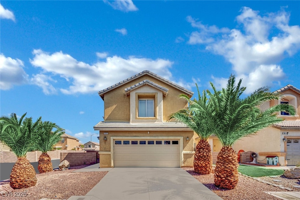 View of front of home with an attached garage, stu