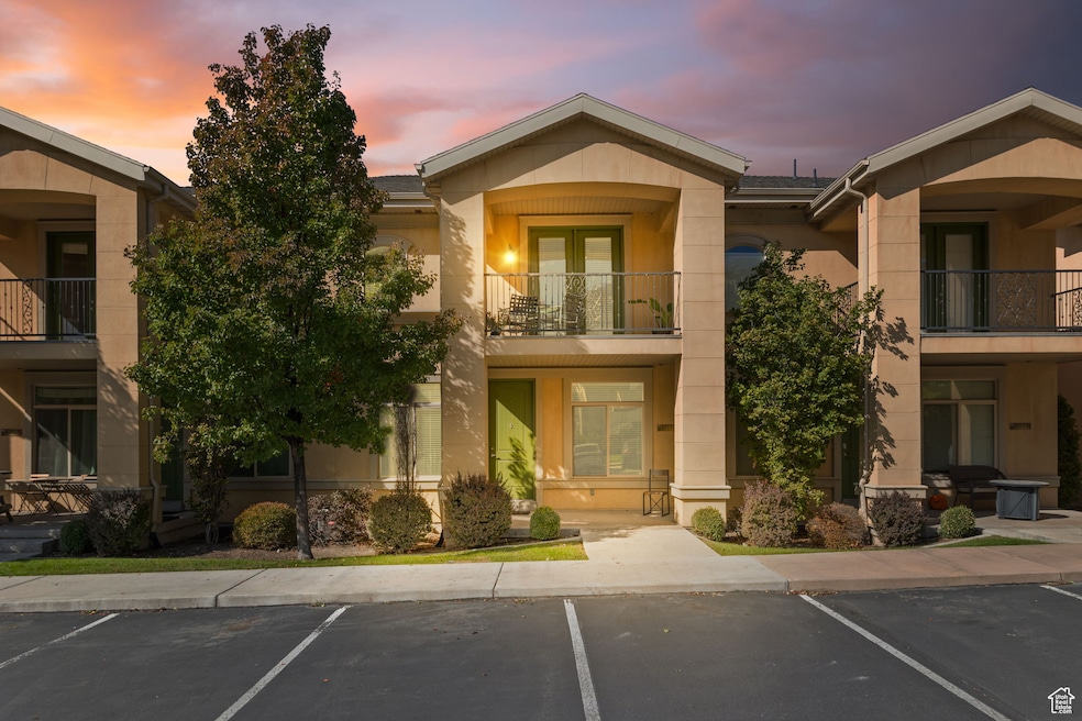Entrance to property featuring uncovered parking and stucco siding