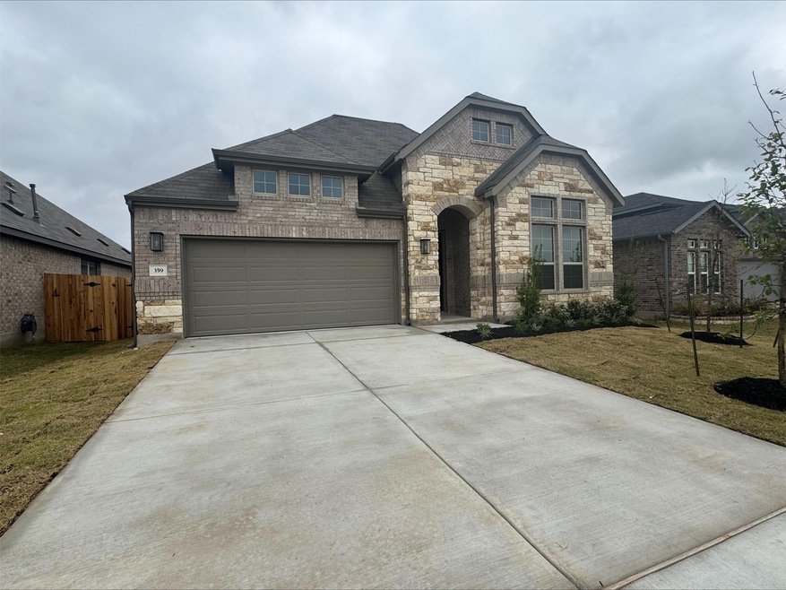 French country inspired facade with stone siding,
