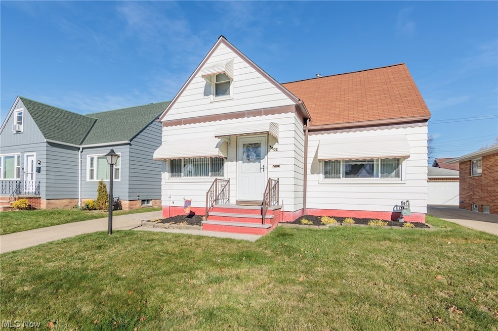 View of front of home featuring a garage and a front lawn