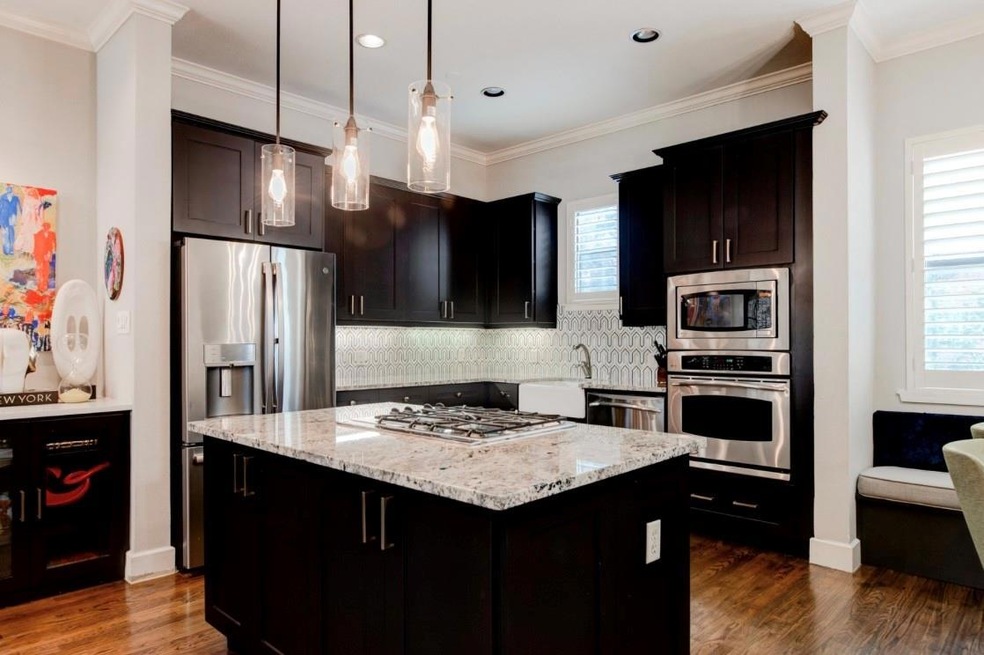 Kitchen featuring crown molding, dark wood-type fl