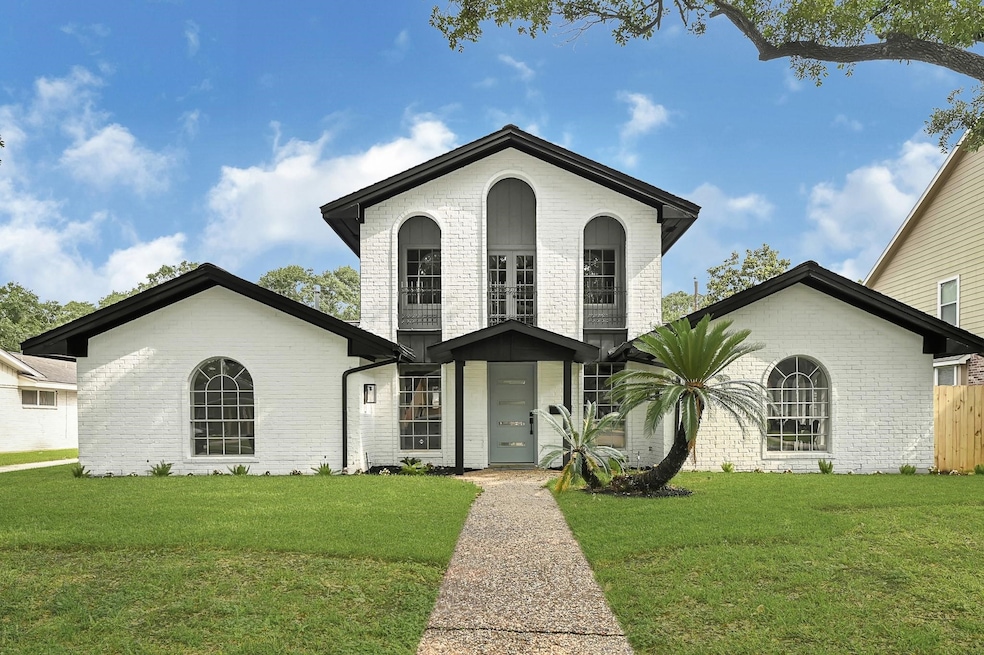 This photo shows a charming two-story white brick