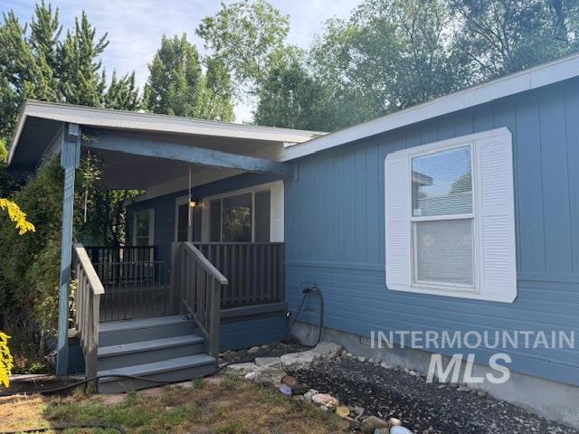 View of front of home featuring covered porch and crawl space