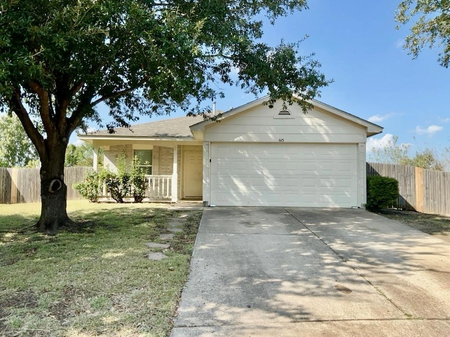 Single story home with a porch, driveway, and an attached garage