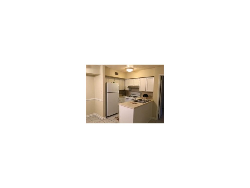Newly painted kitchen cabinets, new stove and hood