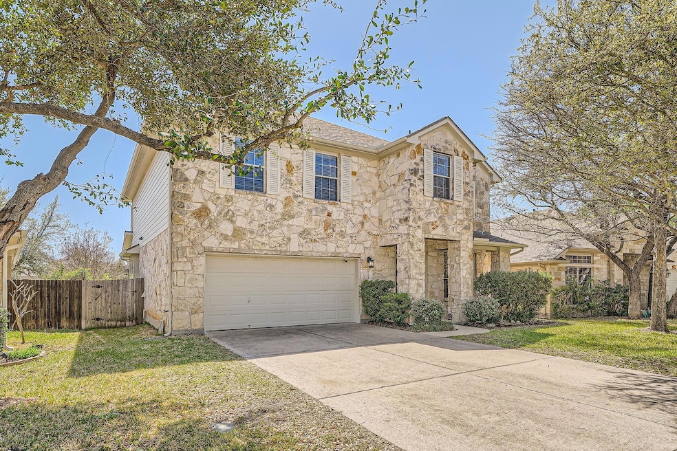 Traditional-style home with stone siding, concret