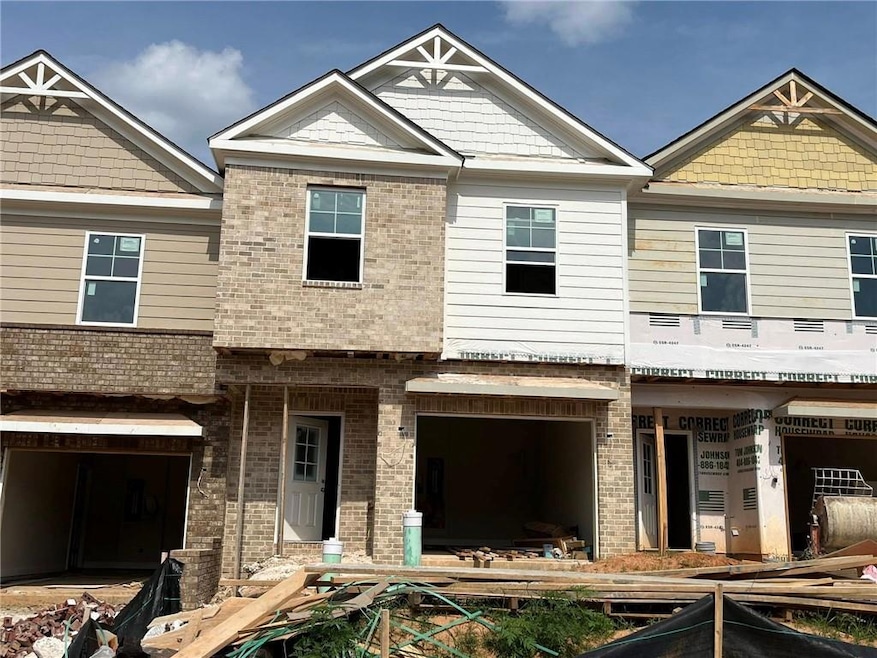 View of front of home featuring brick siding and a garage