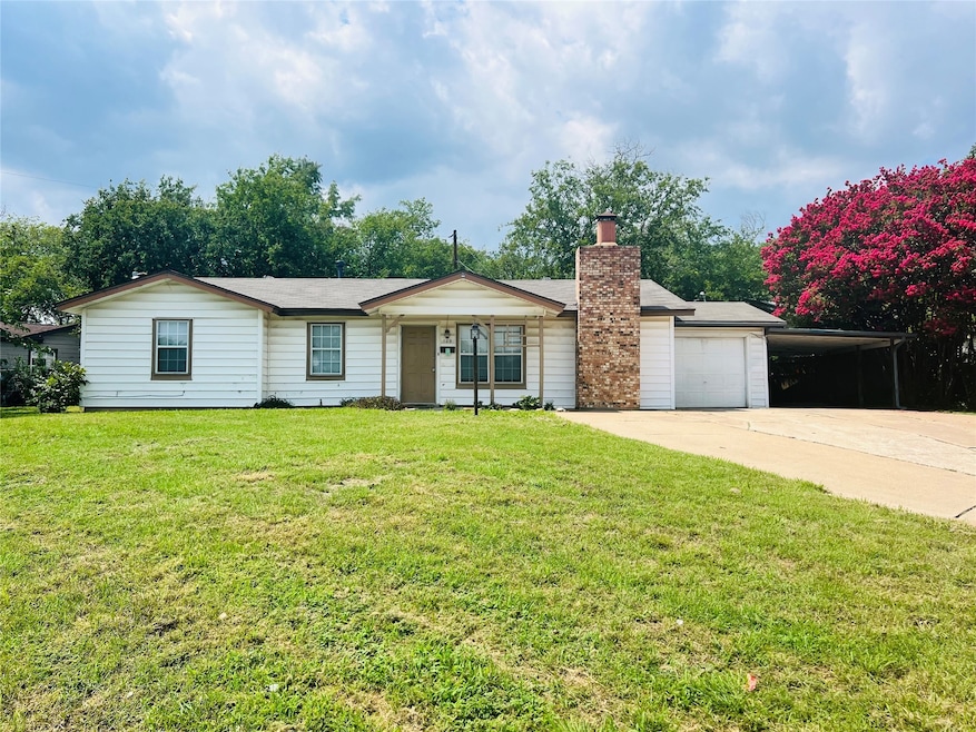 Single story home with a front lawn, driveway, a chimney, a carport, and a garage