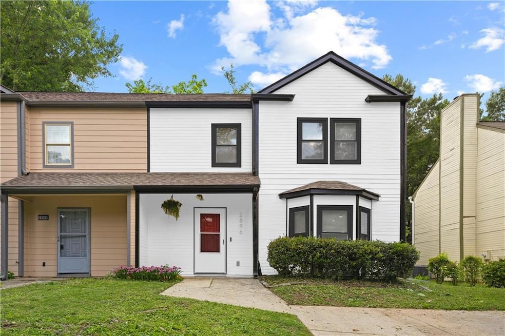 View of property with a front lawn