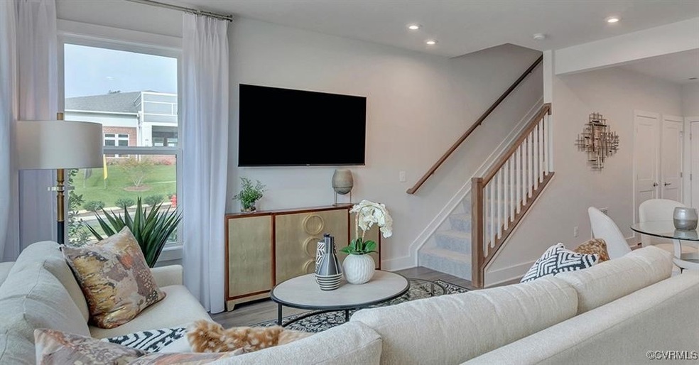 Living area featuring baseboards, stairs, wood fin