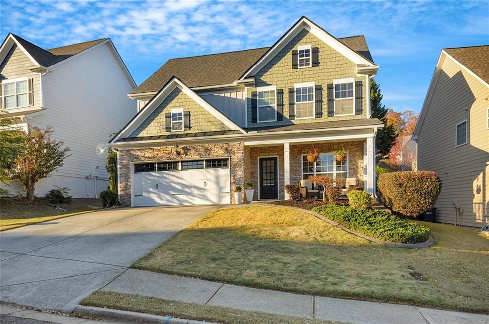 Craftsman-style home with a front lawn, covered po