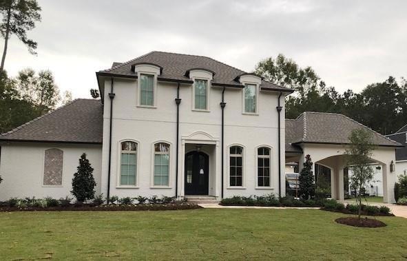 Front of home. Painted brick, custom front doors,