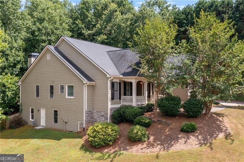 View of home's exterior with covered porch and a l