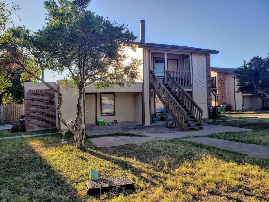Rear view of property with stairway and a patio