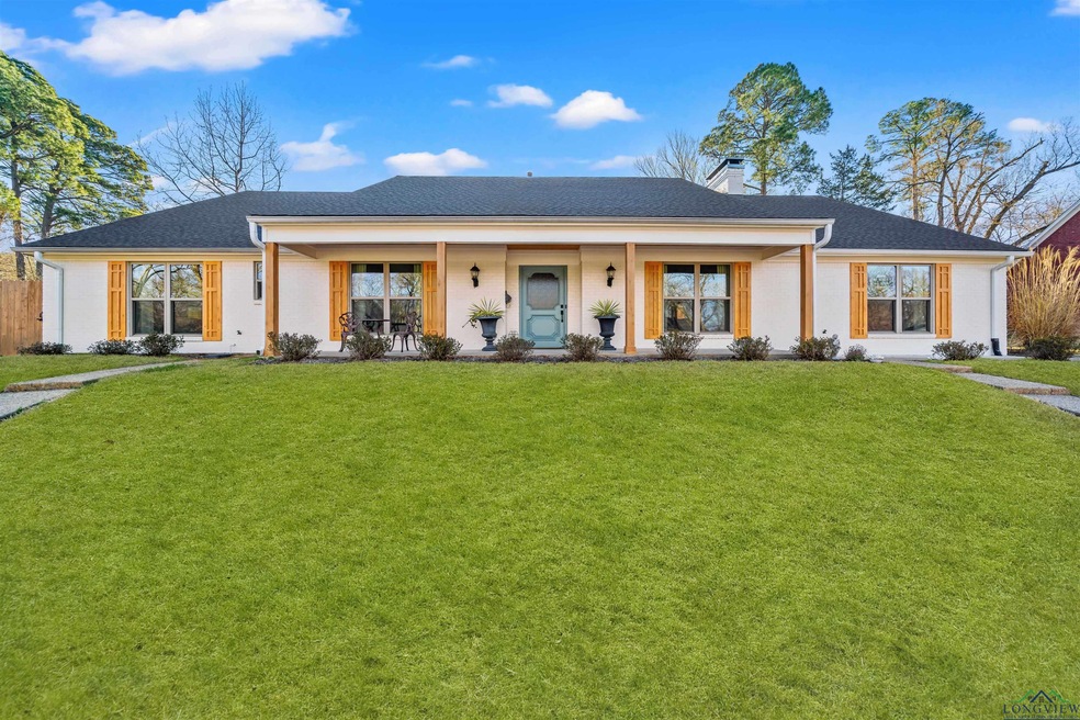 View of front of property with a porch, a chimney,
