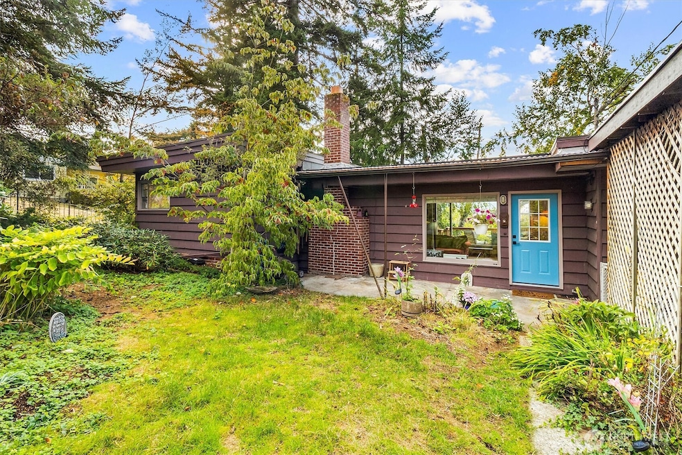 Charming curb appeal with lush landscaping and a welcoming front entry. This home blends natural beauty with timeless architecture.