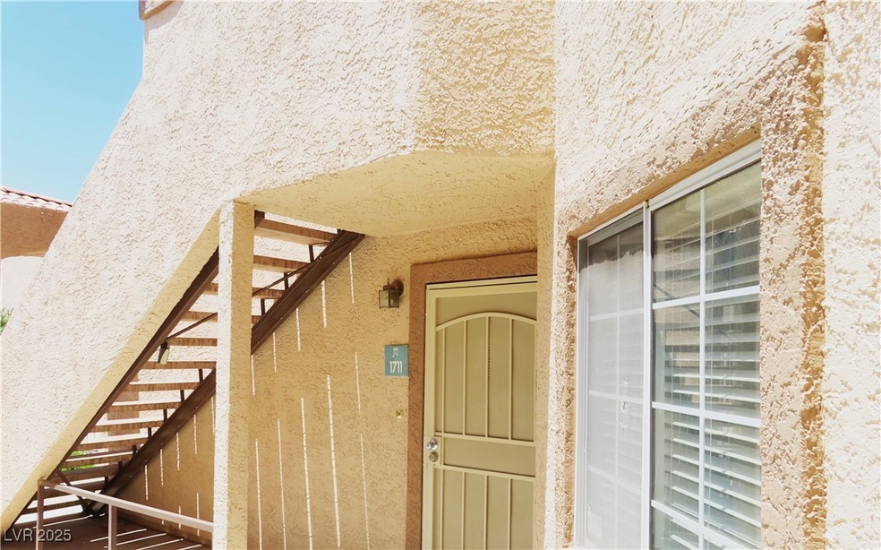 View of exterior entry with stucco siding
