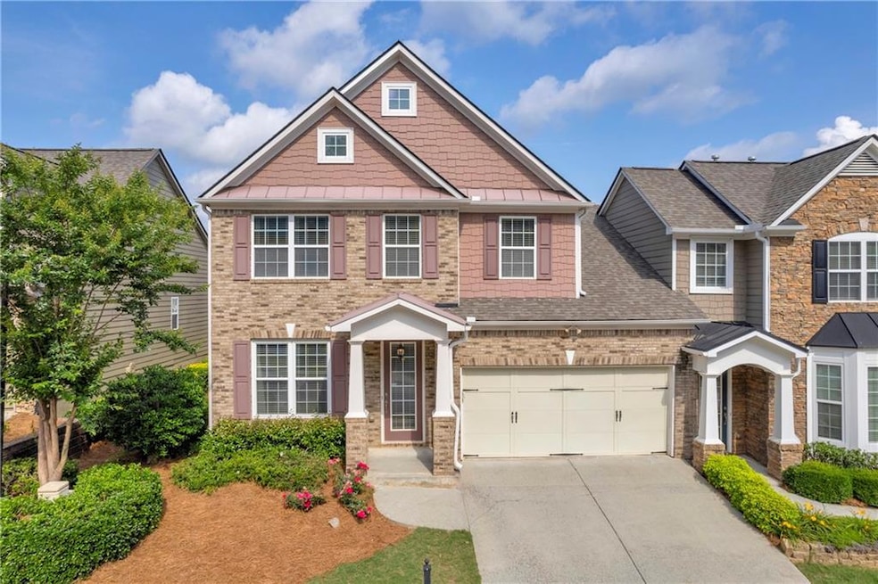 View of front of house featuring concrete driveway, a shingled roof, brick siding, and a standing seam roof