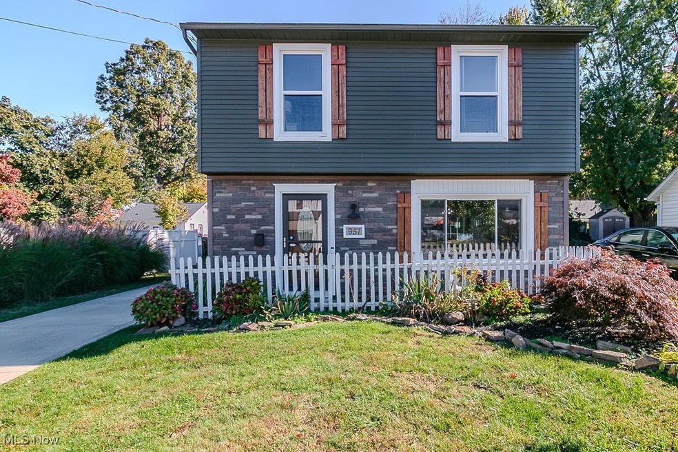 Colonial home with a fenced front yard and stone​​‌​​​​‌​​‌‌​​​‌​​‌‌​​‌‌​‌​​​‌‌​​‌​​​​​‌ siding